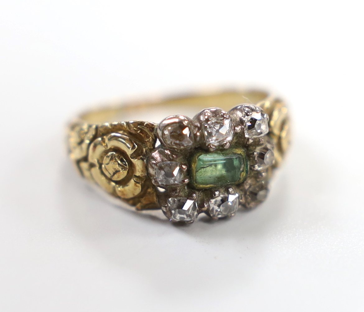 A 19th century yellow metal, foil backed emerald and diamond set rectangular cluster ring, with carved shoulders (shank a.f.), size M, gross weight 4.8 grams.